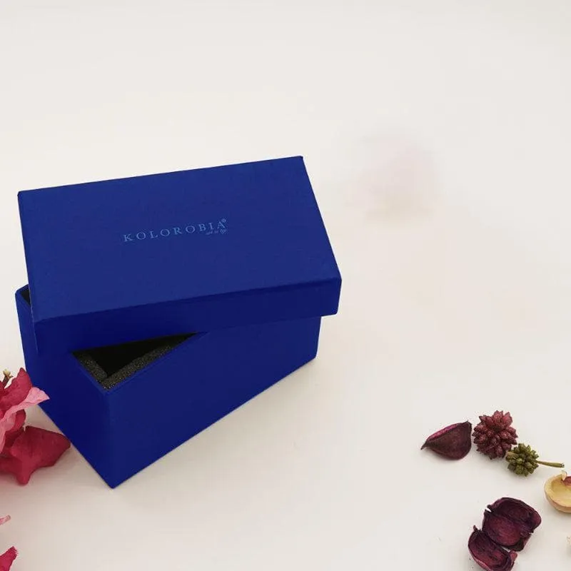 Blue presentation box shown beside dried flowers