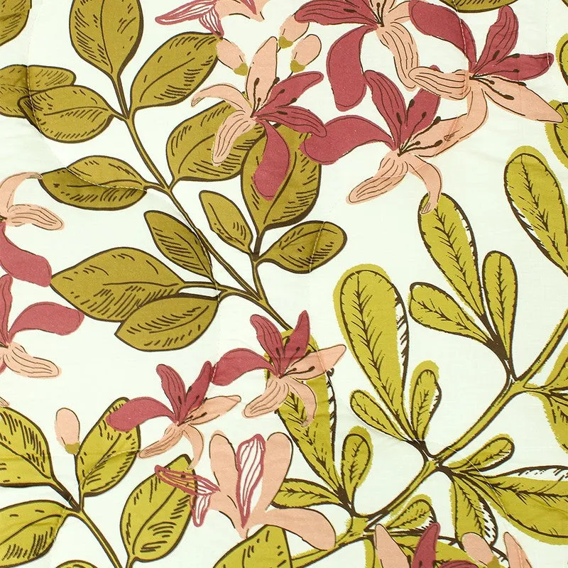 Close-up of pink flowers and olive leaves on the comforter