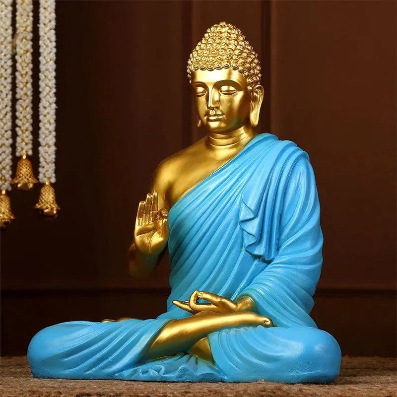 Close view of blue and gold Buddha showpiece with draped robe
