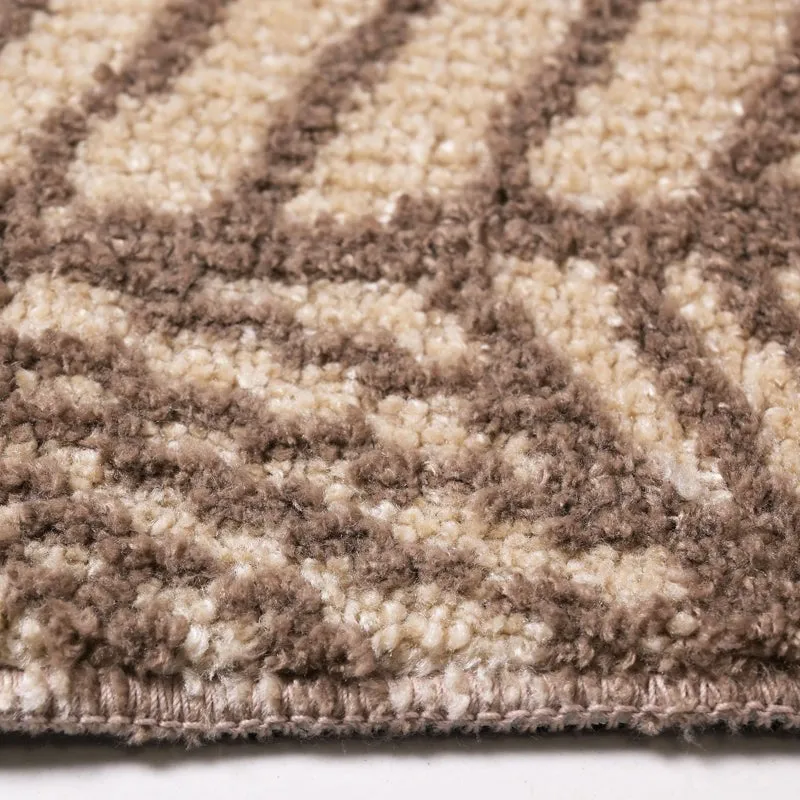 Detailed view of the carpet's brown and beige textured pattern