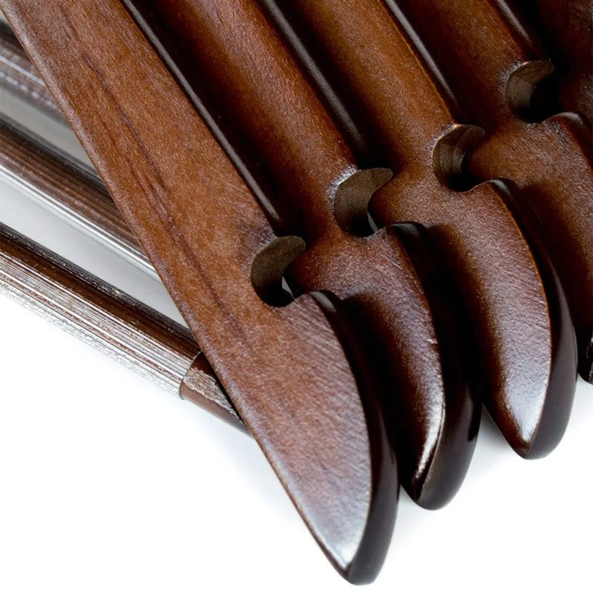 Close-up of brown wooden hanger shoulders with chrome hooks