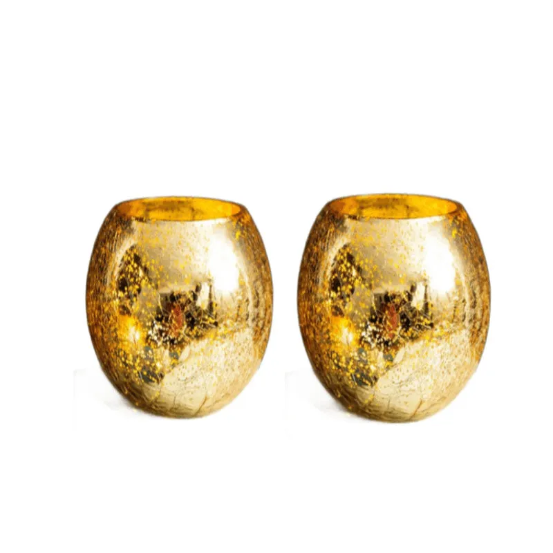 Pair of matching gold glass tea light candle holders on a white background