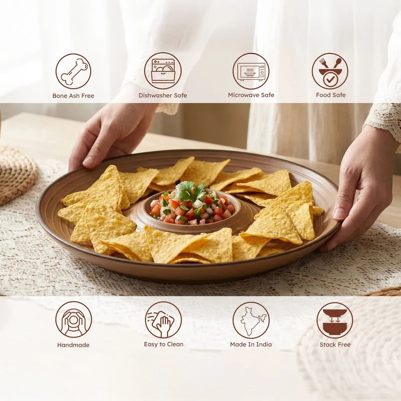 Hands holding a brown chip and dip platter filled with tortilla chips and salsa