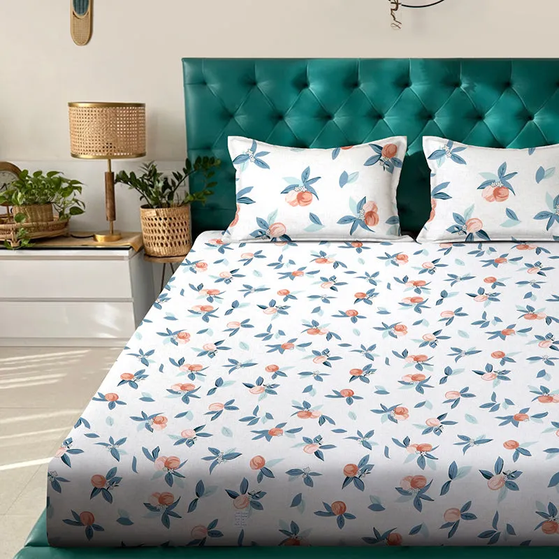 White floral flat bedsheet with two matching pillow covers on a bed