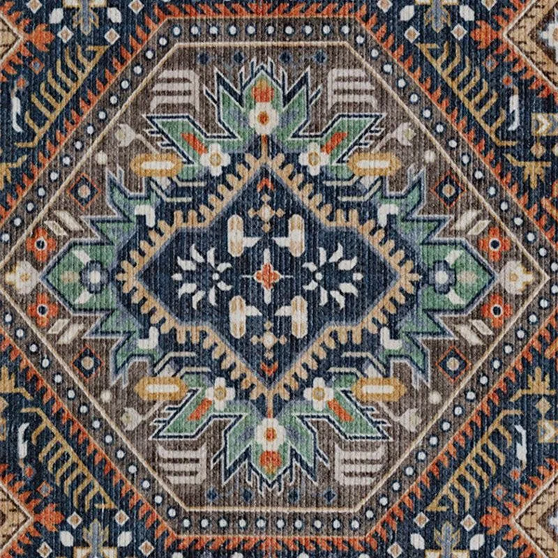 Close-up of central geometric ethnic motif in navy, green and peach