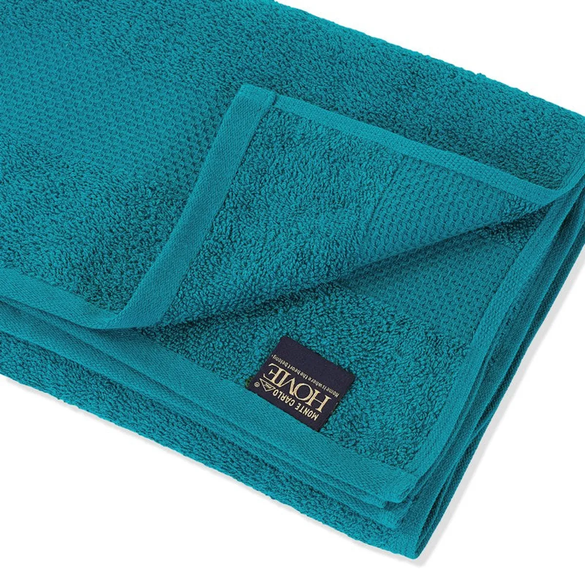 Close-up of the teal towel's soft textured surface and border