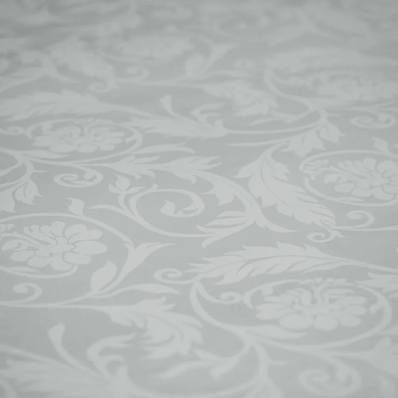 Close-up of the light grey floral jacquard pattern on the duvet cover