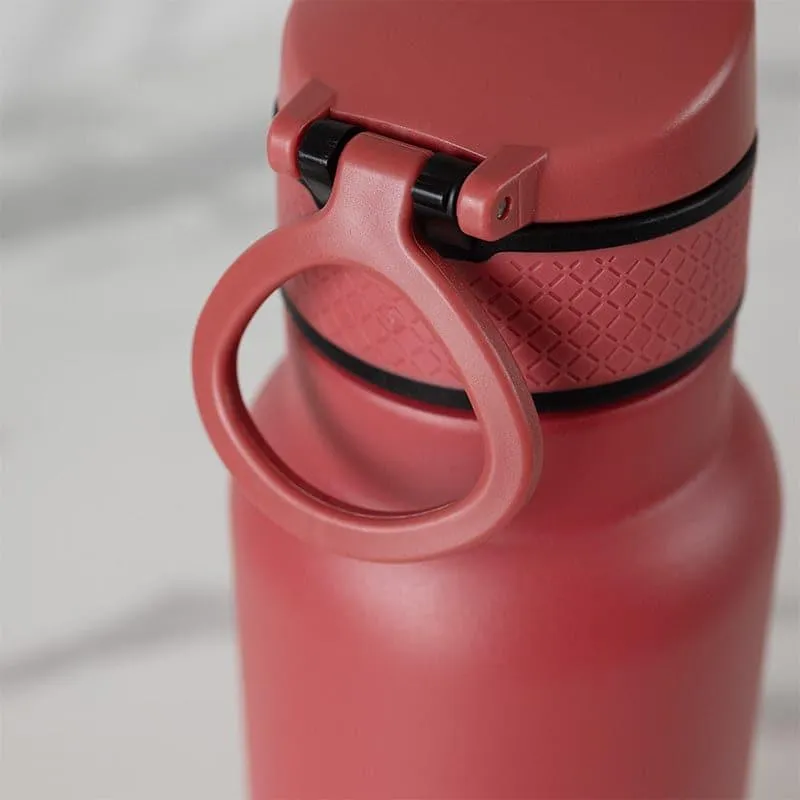 Close-up of red bottle showing textured grip band and carry loop