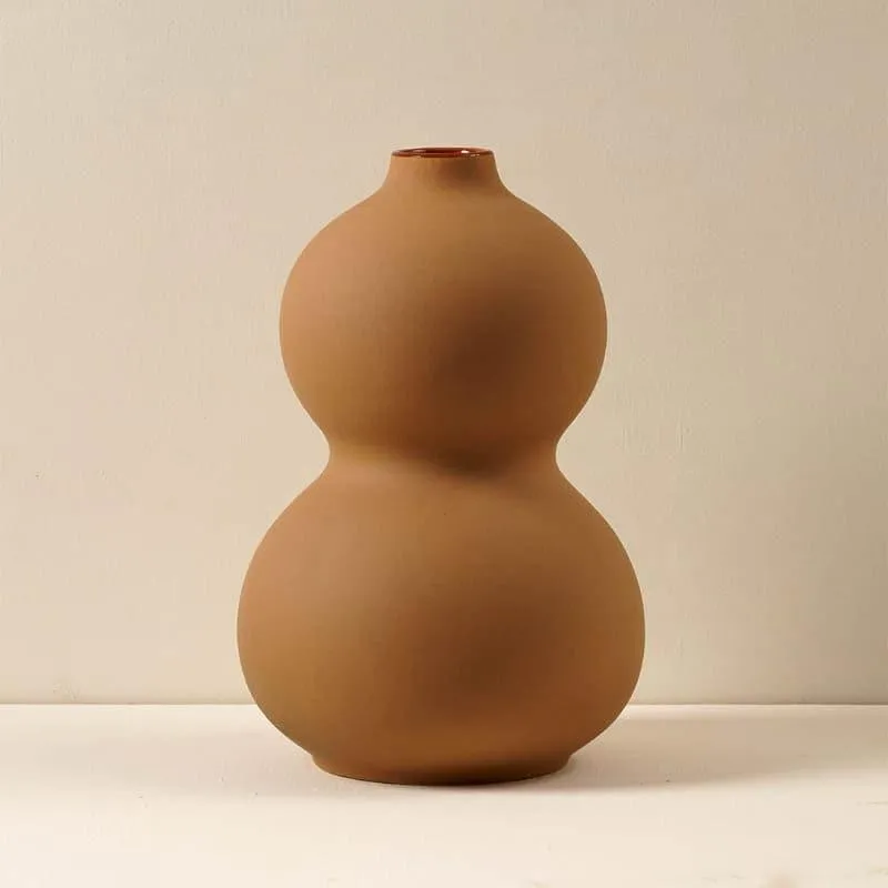 Brown ceramic vase with a smooth rounded bubble silhouette
