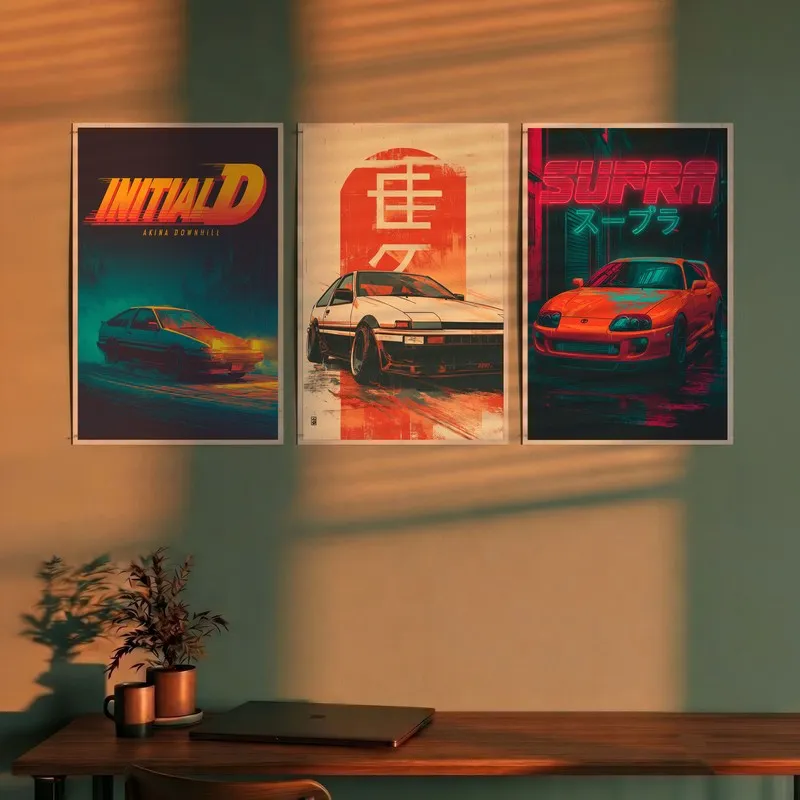 Set of three car-themed wall posters displayed above a desk in warm light