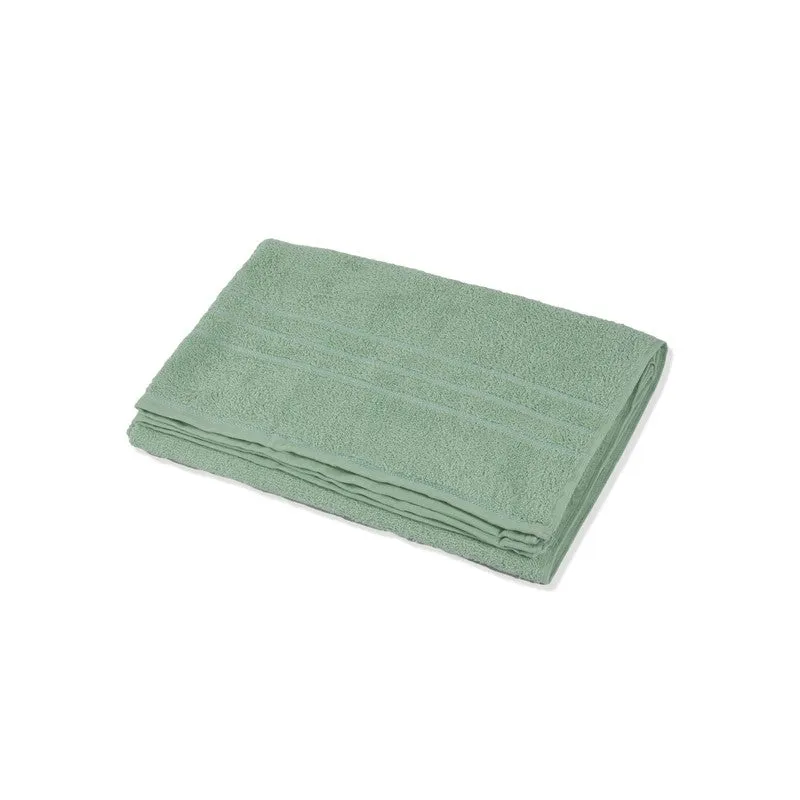 Folded sage green bath towel on a white background