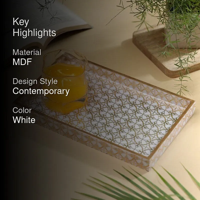 White and gold geometric serving tray styled with a glass and greenery