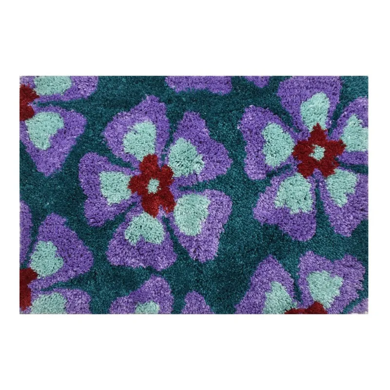 Close-up of the textured blue bath mat with purple and mint floral motif