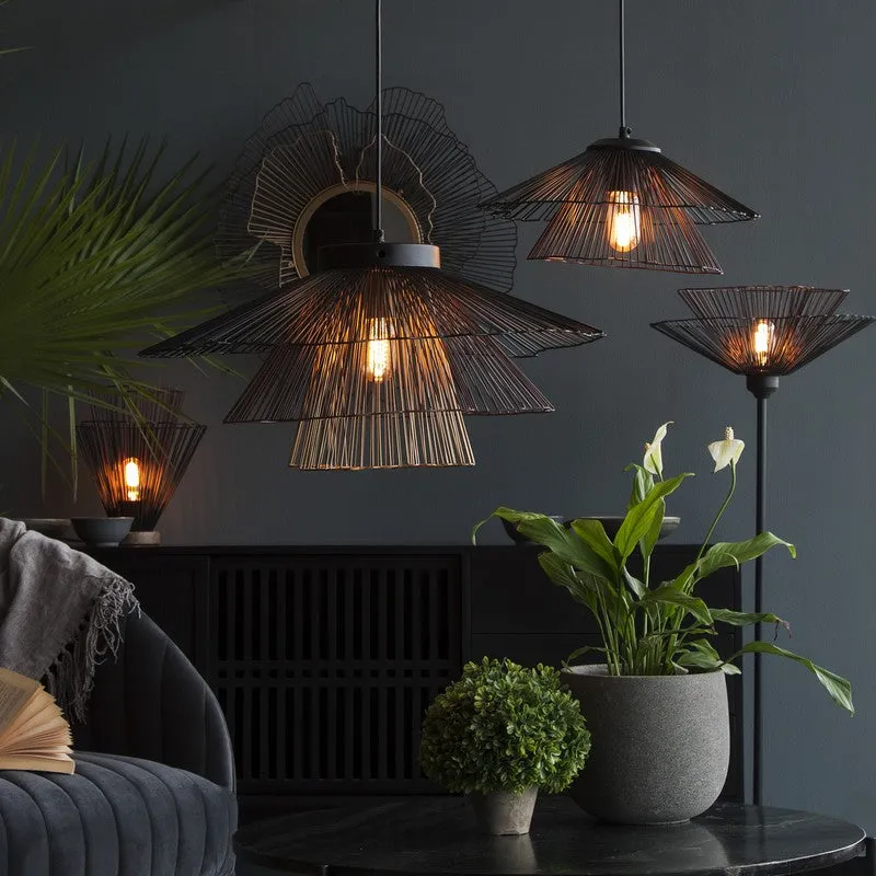 Black wire pendant lamps styled in a dark living space