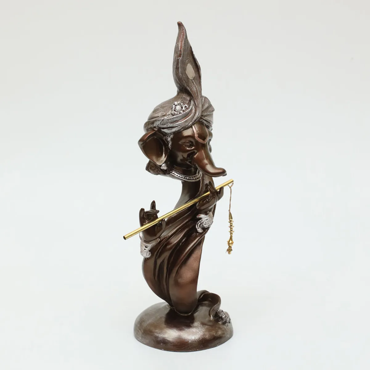 Angled side view of a brown Ganesha showpiece with a curved sculptural body