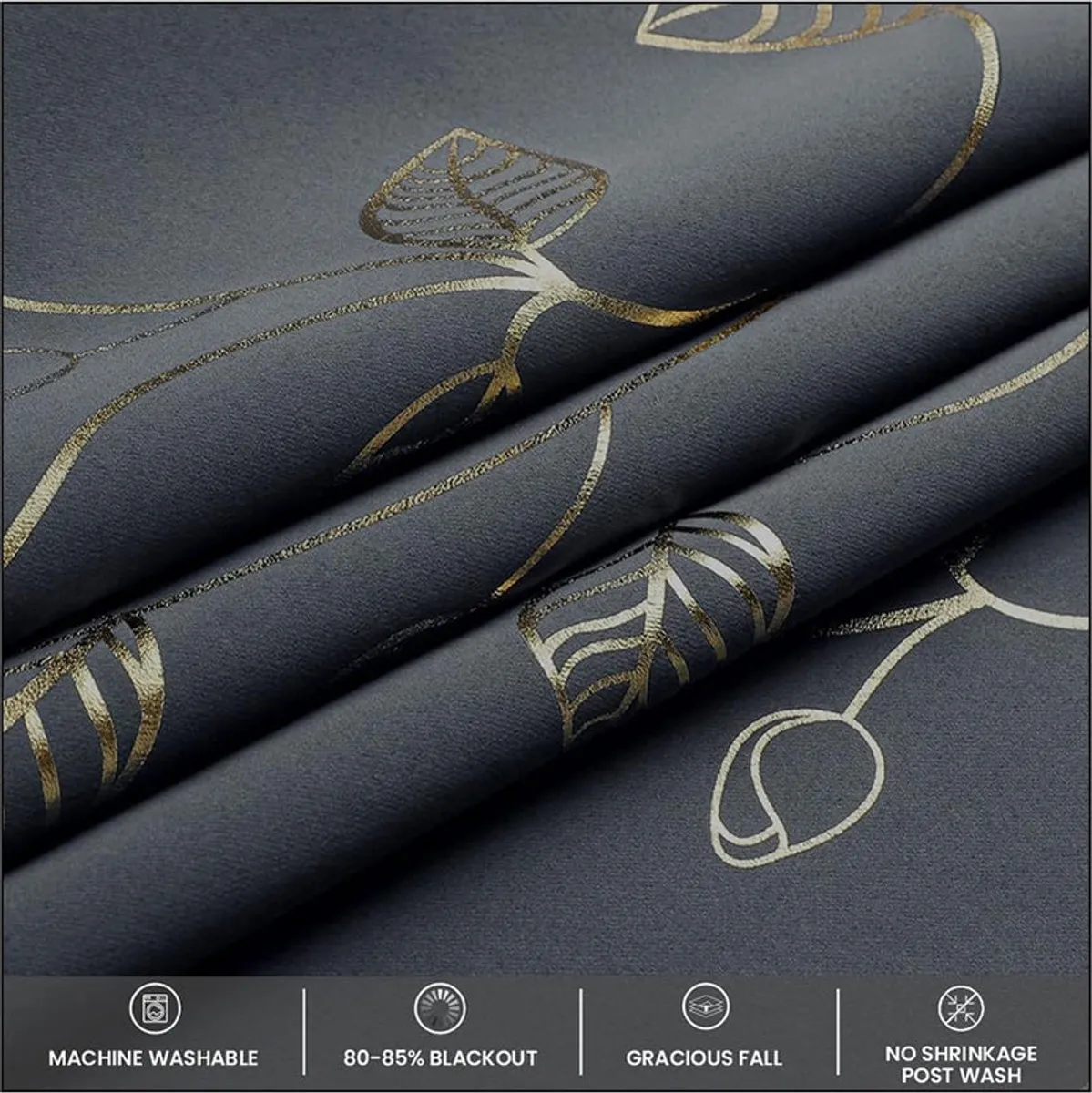 Dark curtain fabric with metallic leaf pattern draped across a surface.