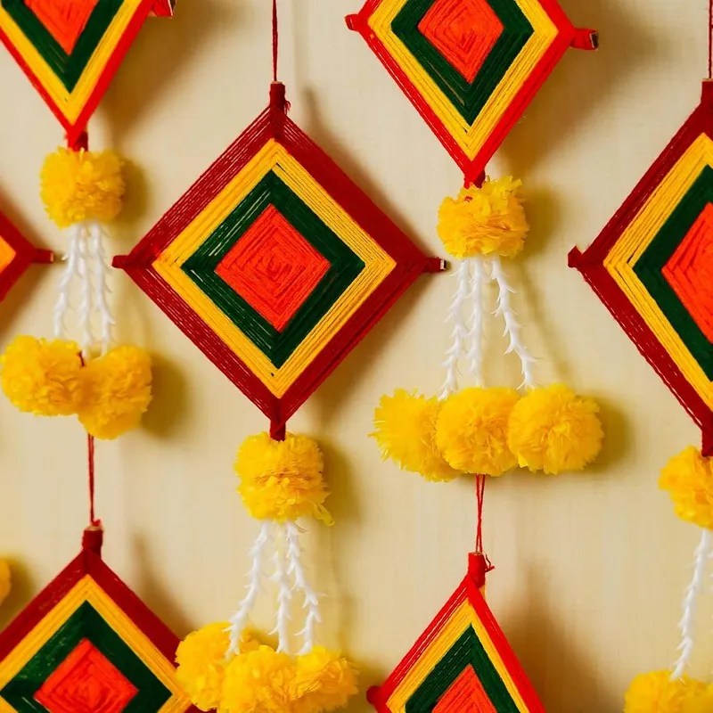 Close-up of multicolour square latkans with yellow pom-pom details