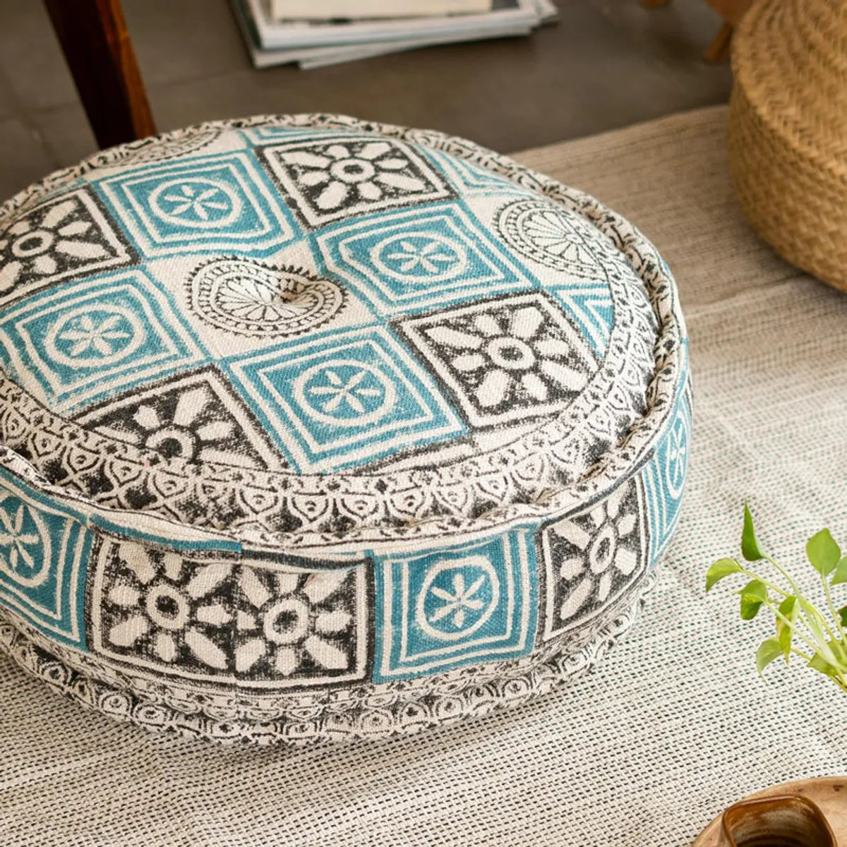 Close-up of the blue, cream and black geometric pattern on the round floor cushion.