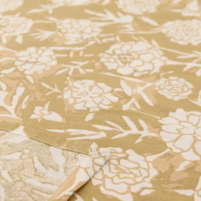 Close-up of beige bedsheet with white floral print
