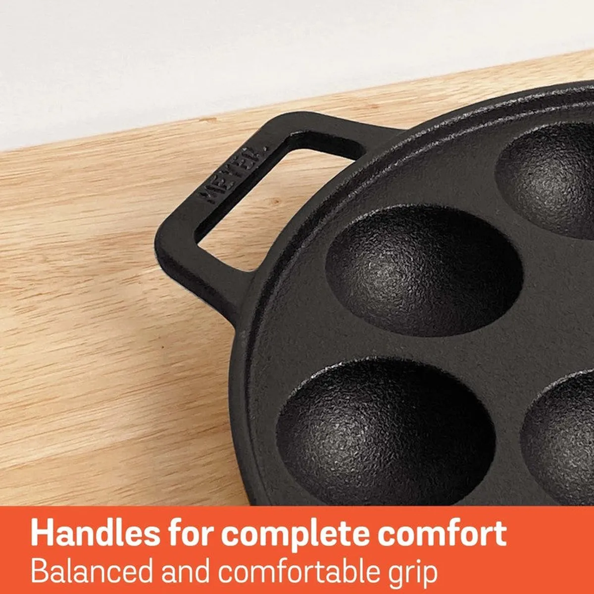 Close-up of the cast iron pan's dual handle and textured surface