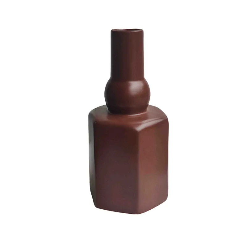 Brown totem-style vase on a plain white background