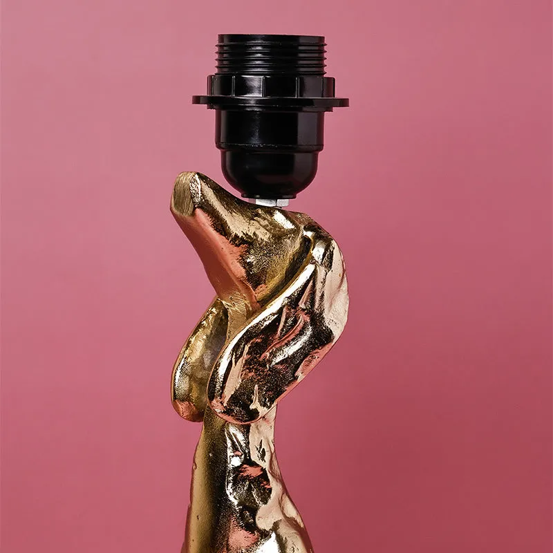 Close-up of the lamp's gold sculptural upper section and black bulb holder