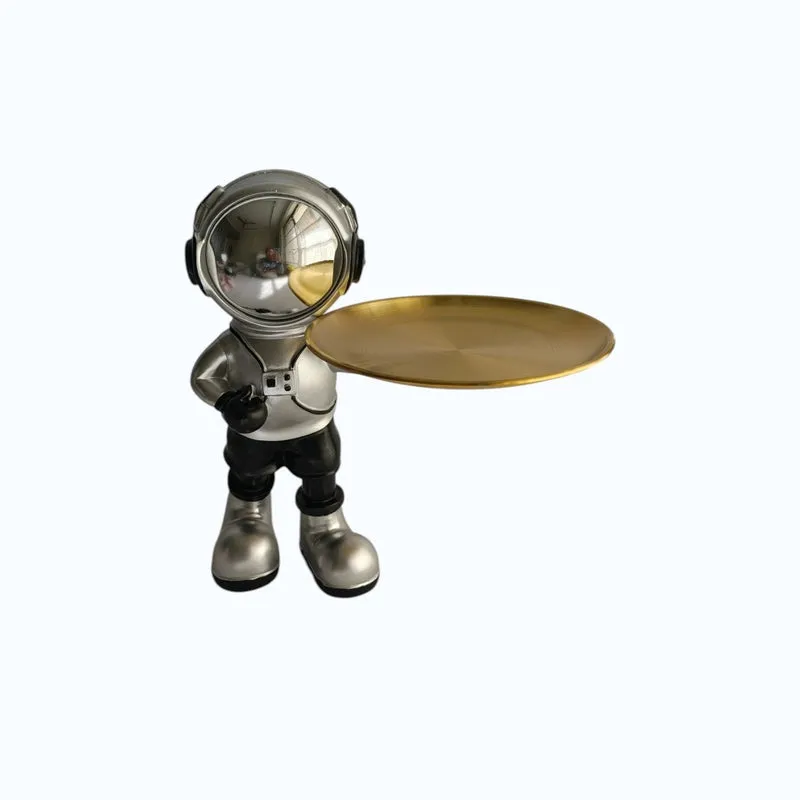 Front-facing astronaut tray figurine with silver, black and gold details