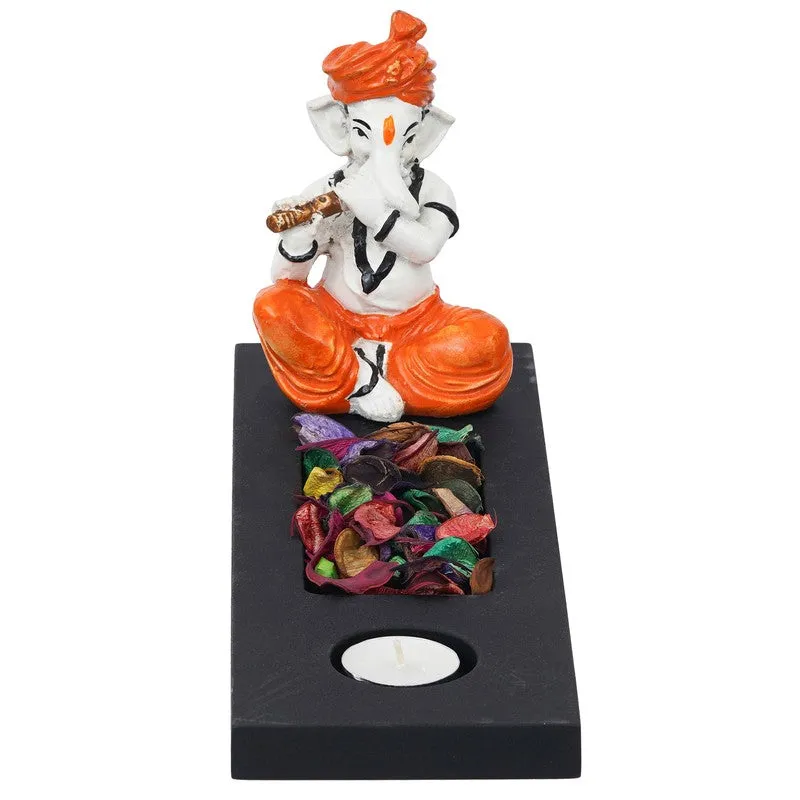 Front view of Ganesha tea light candle holder in orange, white and black