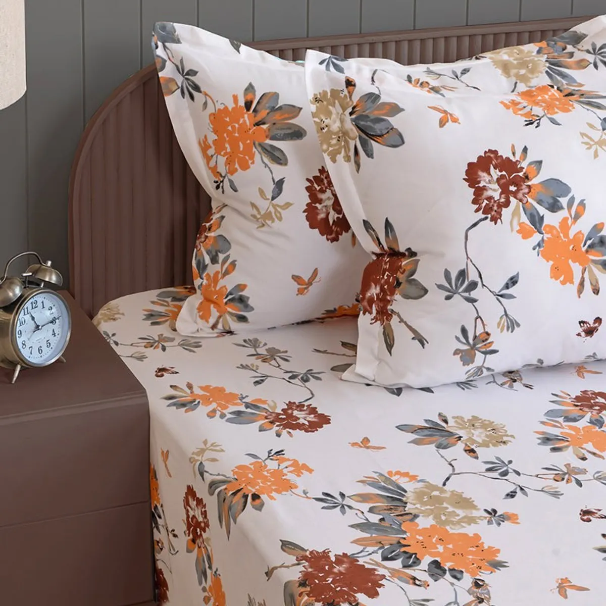 Close-up of matching floral pillow covers on white bedsheet