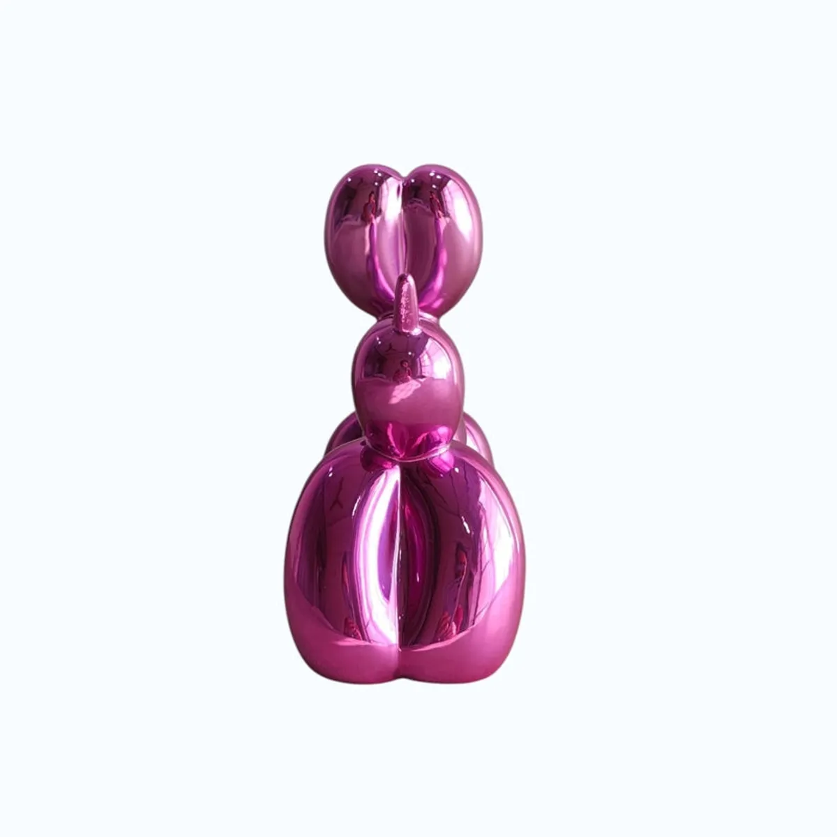 Rear view of a glossy pink balloon dog showpiece on a plain light background.