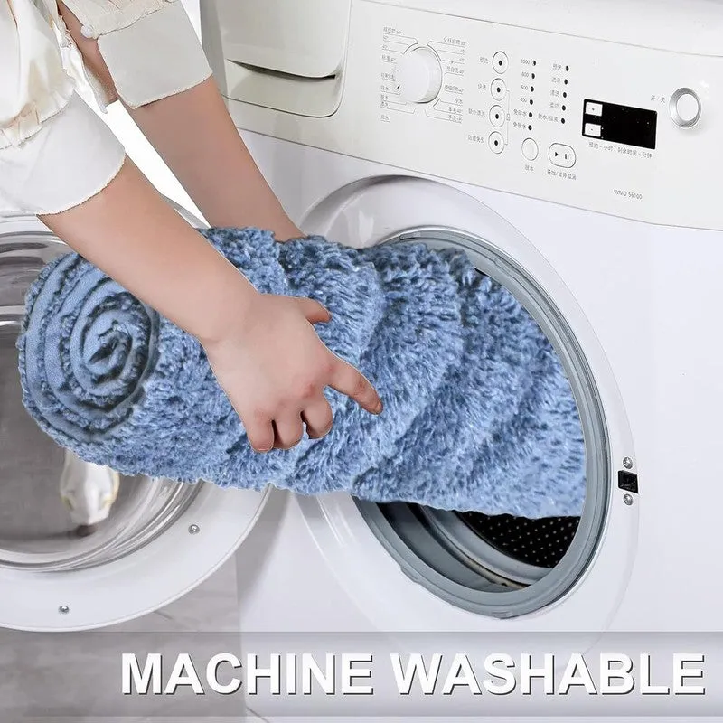 Blue bath mat being placed into a front-loading washing machine