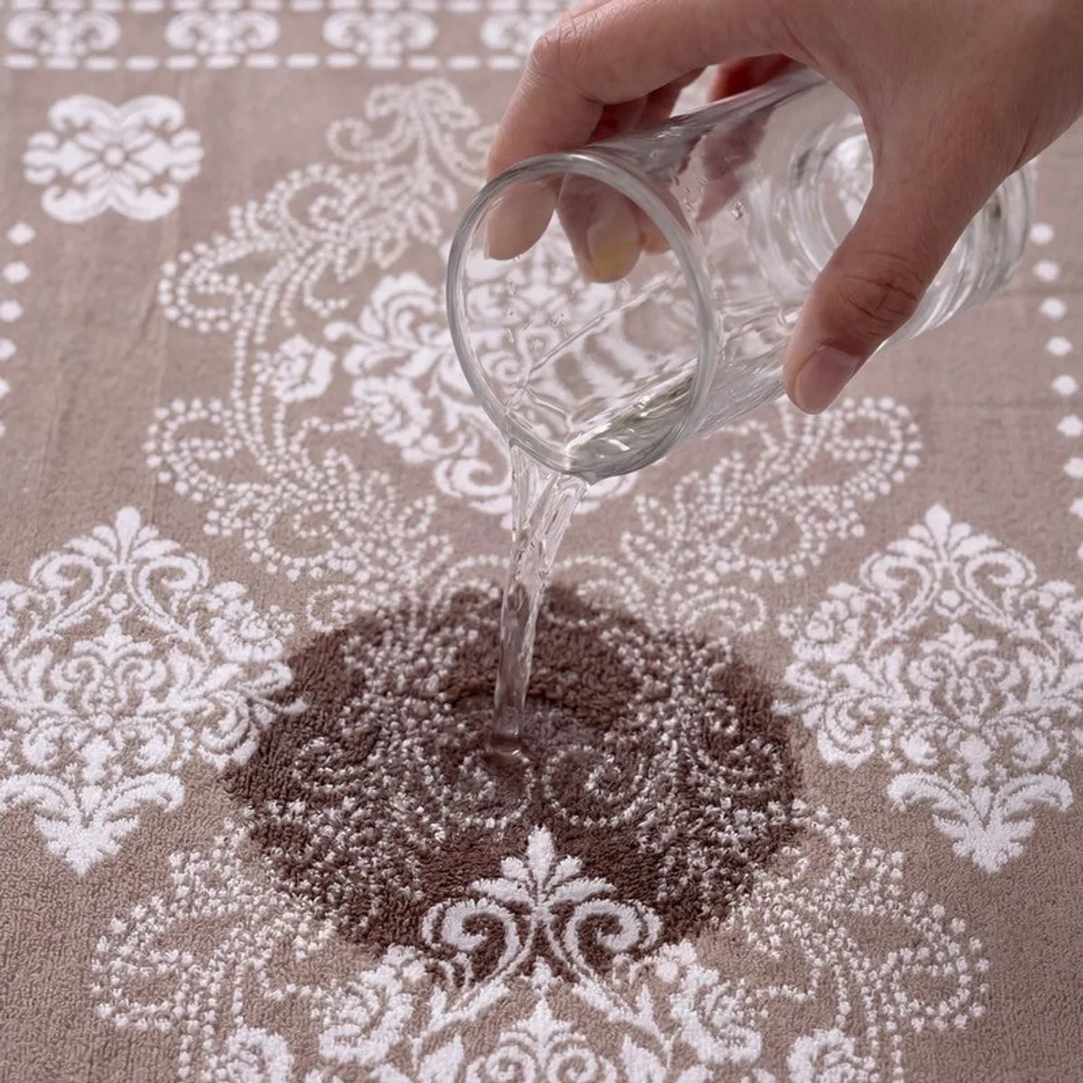 Water being poured onto the floral cotton towel
