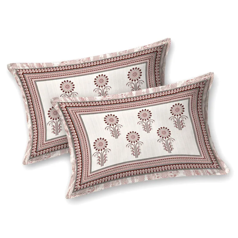 Two matching pink and white floral pillow covers