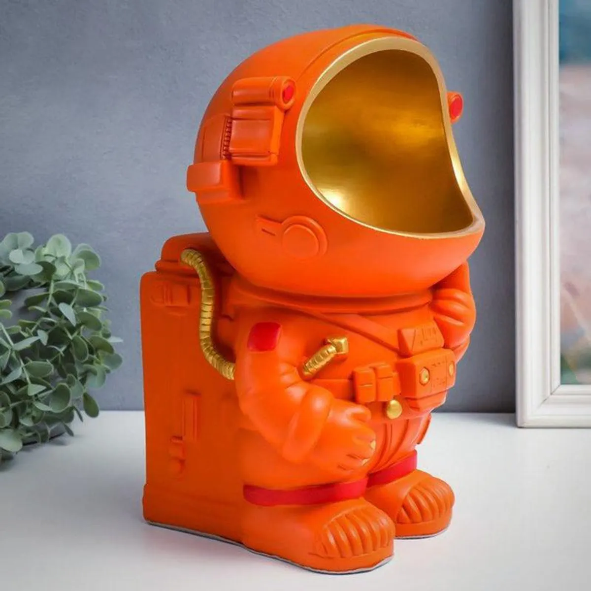 Side view of the orange astronaut tissue holder showpiece
