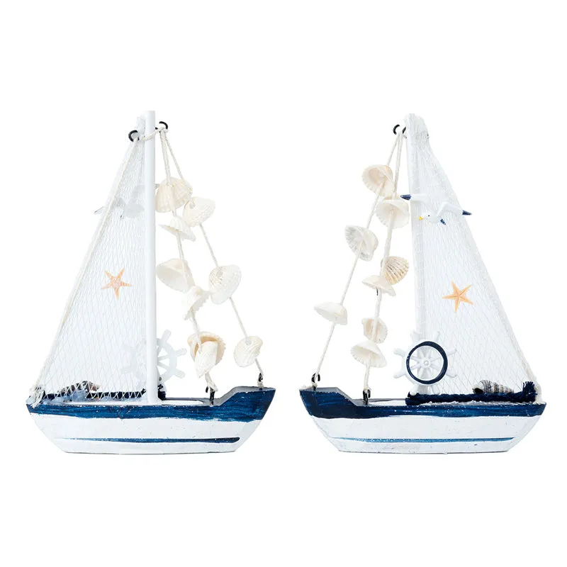 Two white and blue sailboat showpieces shown side by side on a white background