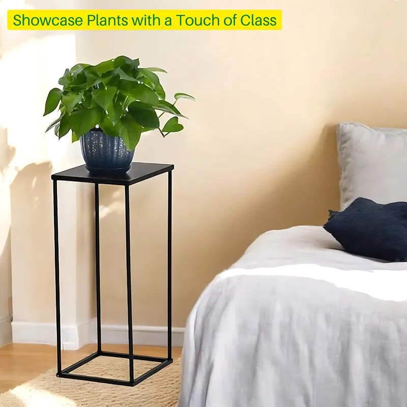 Black metal plant stand displaying a leafy plant beside a bed.