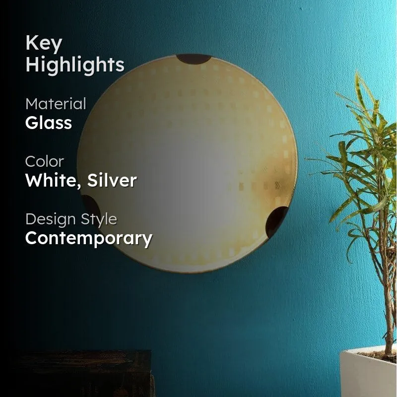 Lit round wall lamp on a blue wall with a plant and dark furniture edge