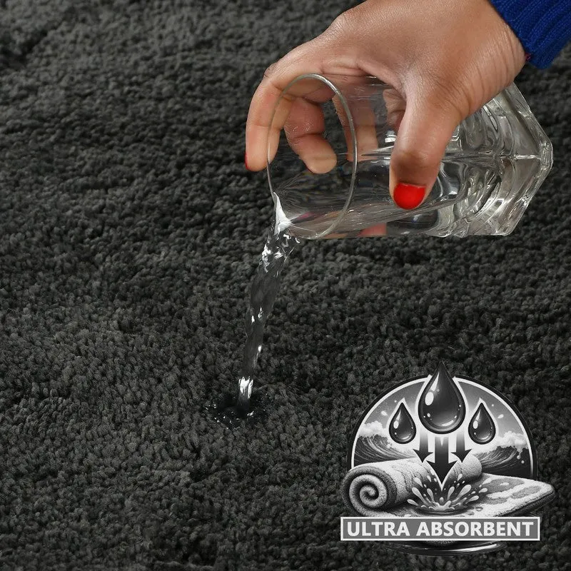 Close-up of water being poured onto the dark grey bath mat