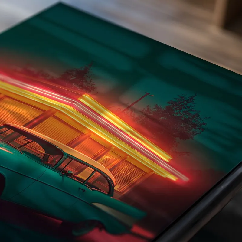 Close-up of a teal classic car poster with neon-lit building