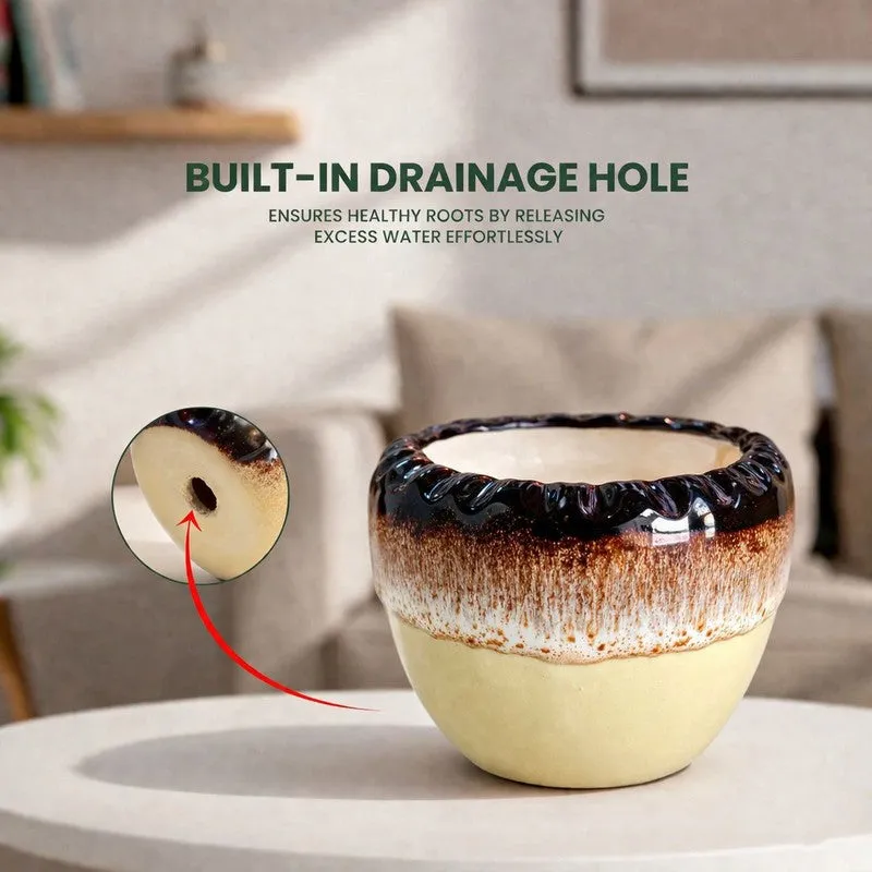 Close view of a round ceramic planter showing its glossy dark rim and warm finish