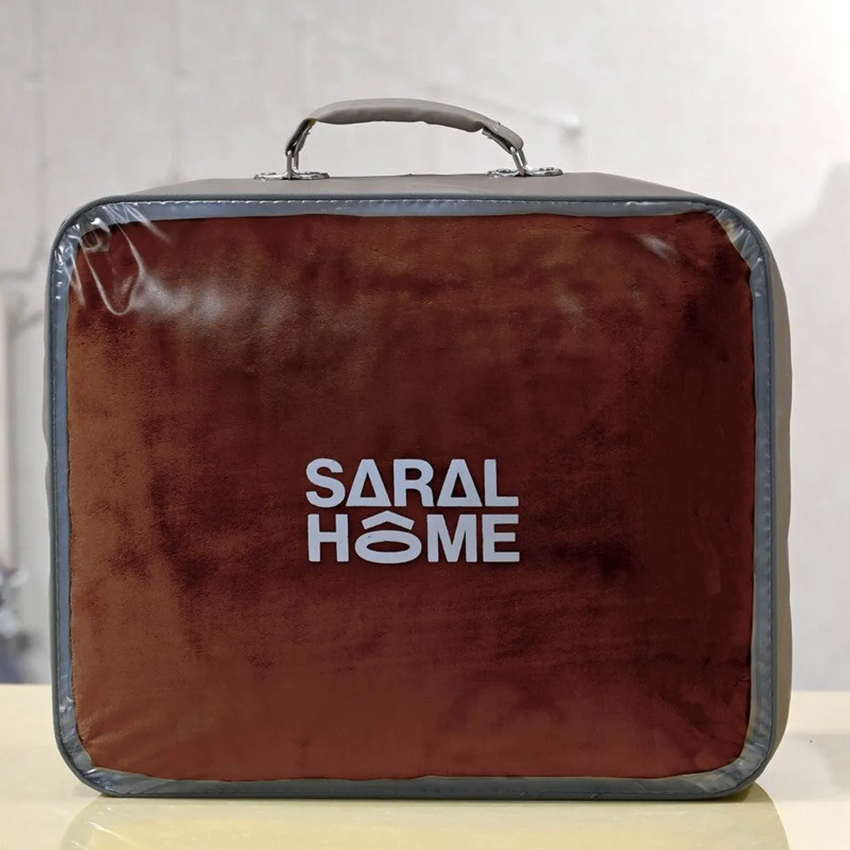 Brown blanket packed in a handled transparent storage case