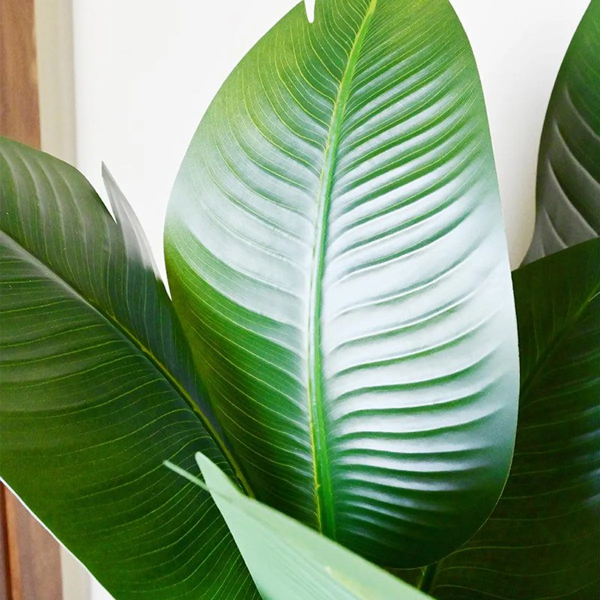 Close-up showing glossy green and pale green artificial leaf textures