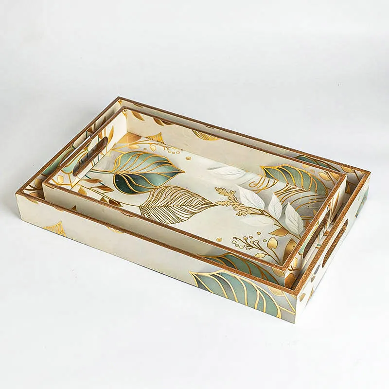 Nested rectangular serving trays with botanical pattern and cutout handles