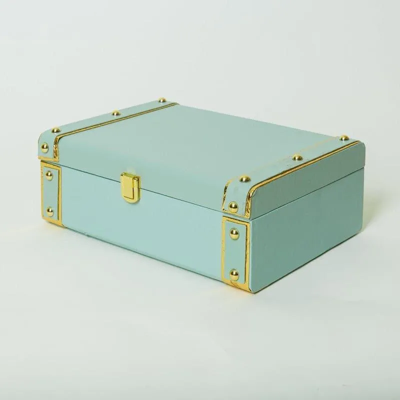 Closed mint green gift box with gold-toned trim