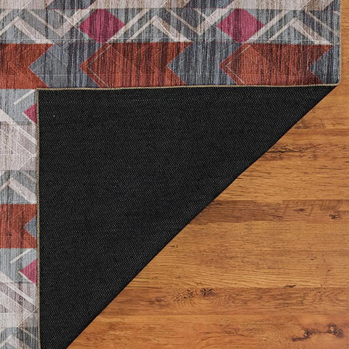 Underside corner of the carpet showing the black backing