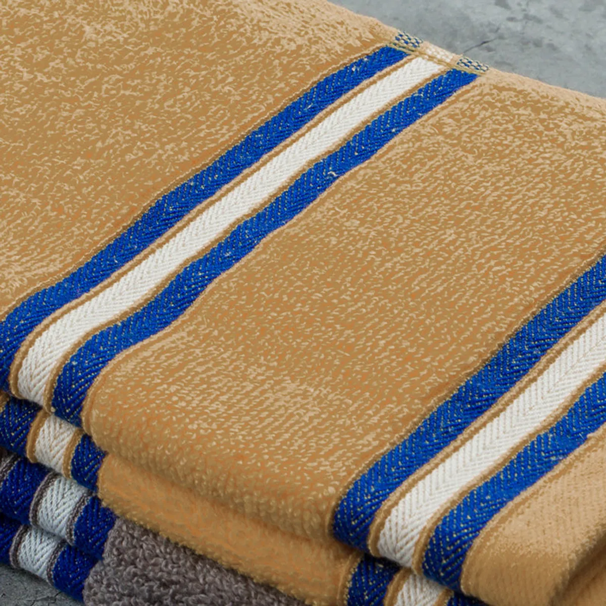 Close-up showing the towel's soft textured surface and blue stripes
