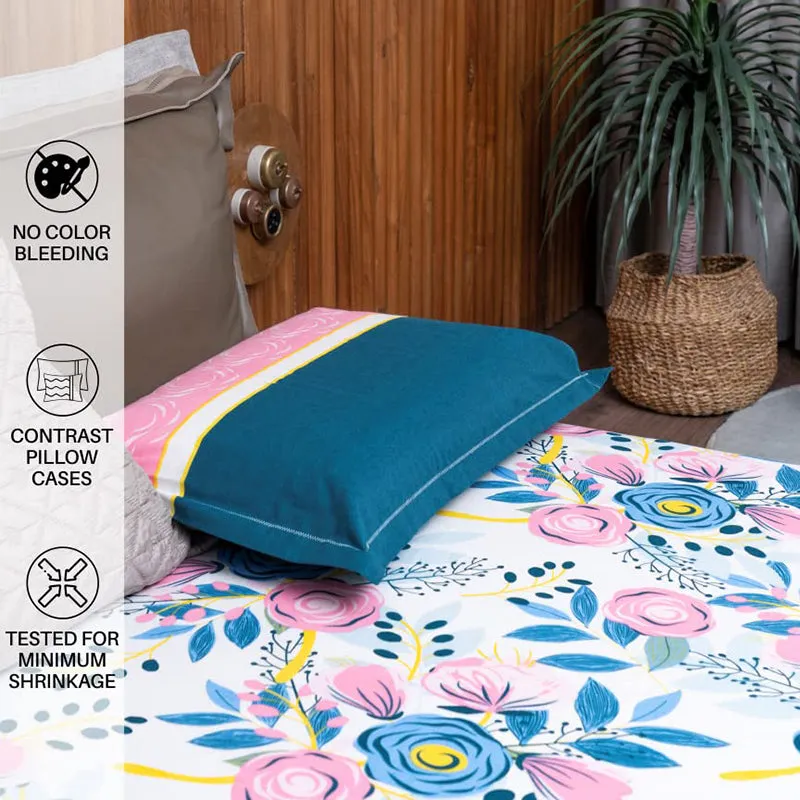 Close-up of blue contrast pillow cover on floral bedsheet