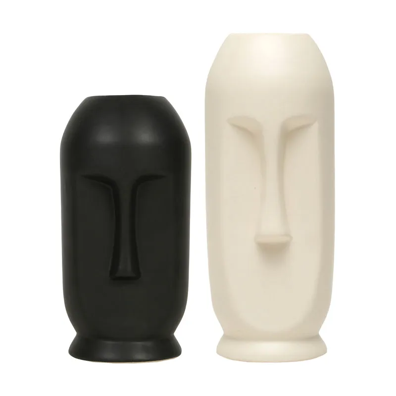 Set of two face vases in black and white on a plain background