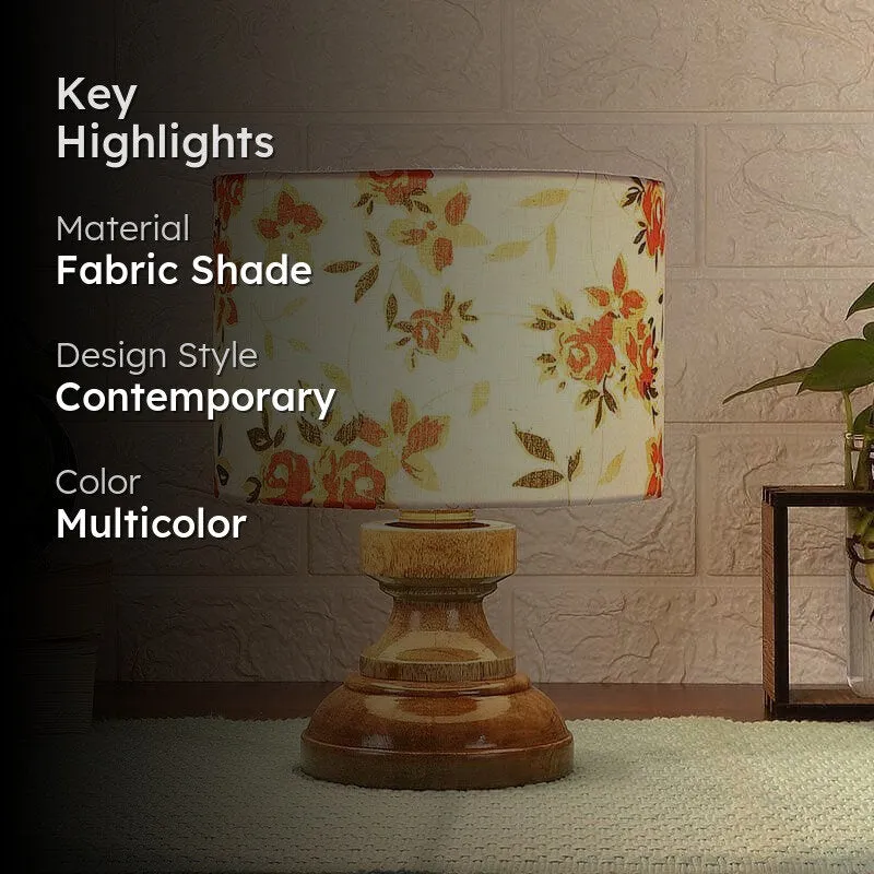 Lit floral table lamp in a styled room with a dark text panel on the left