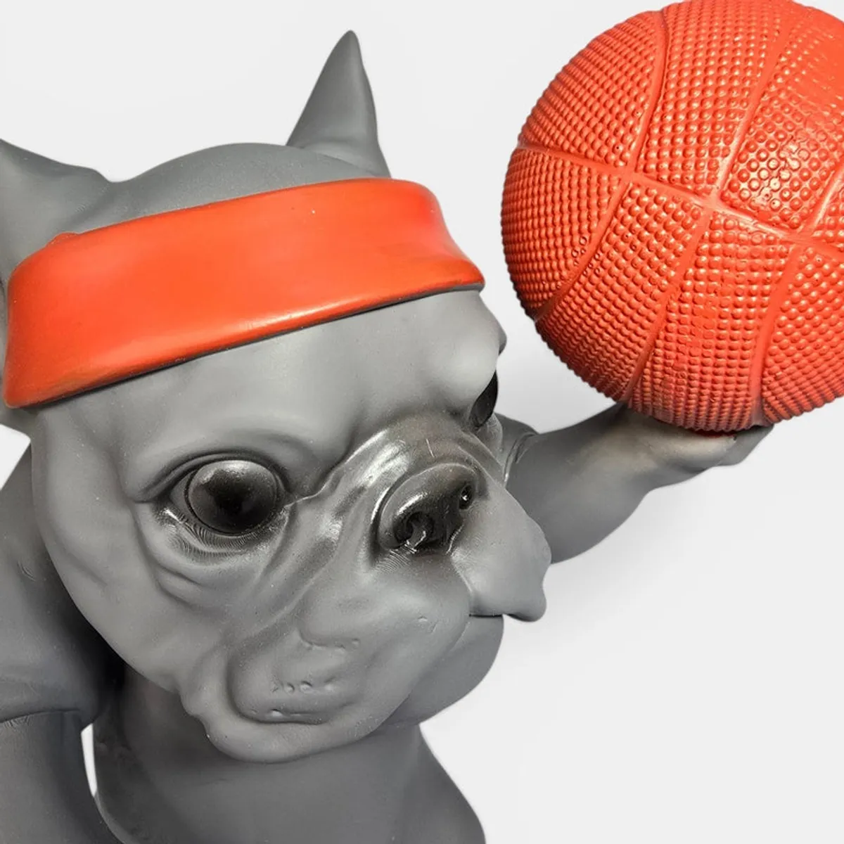 Close-up of the bulldog face, orange headband and textured basketball